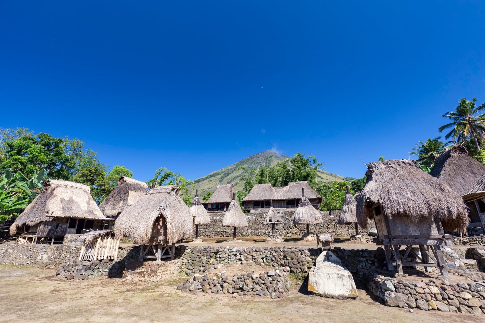 Male and female ancestral shrines known as Ngadhu and Bhaga in the terraced courtyard in the Luba Village near Mount Inerie, Indonesia.